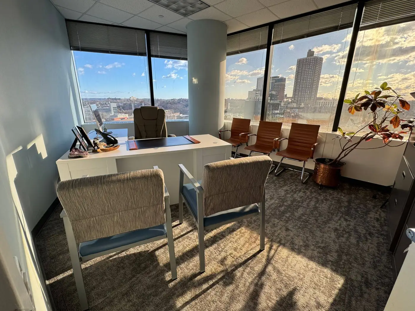 A sunlit private meeting office at Arandia Law Firm with city views.